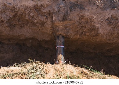 Deep Trench In The Ground With A Water Pipe