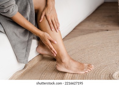Deep vein thrombosis and varicose of african woman. Girl touching her legs and looking at veins. Sclerotherapy procedure at visiting vascular surgeon doctor