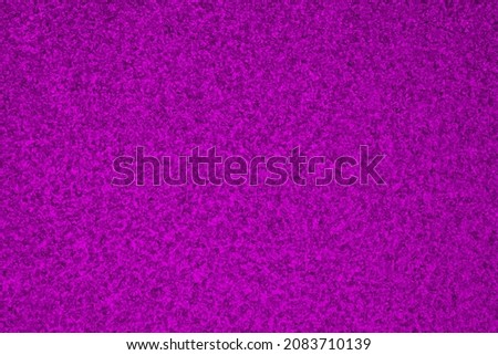 Deep violet winter background. Rich saturated bright color. Dark purple tinted wallpaper. Ice crystals surface on window glass close-up. A pattern of chaotic spots