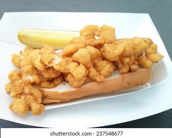 Deep-fried Clam Strips On A Bun With A Pickle