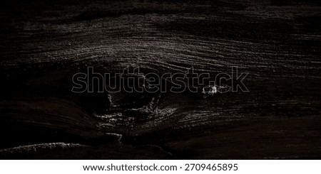 Deeply textured and dramatic dark brown tree bark or wood surface, featuring a rough grain, deep crevices, and a heavy vignette that creates a moody, mysterious background