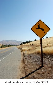 Deer Crossing Warning Sign Along Lonely Road In California.