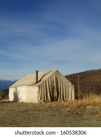 Deer Hunting Camp In The Mountains With An Old Canvas Wall Tent And A Wood Stove Chimney Pipe. National Forest Wilderness Camping In Fall / Autumn Washington Oregon Montana Idaho Wyoming Colorado