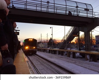 Deer Park, New York - January 26, 2016: Commuters on Long Island await an approaching LIRR train on the platform returning to work after Blizzard Jonas shut down parts of the NY area. 