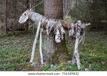 Deer sculpture made of wood and natural materials in a forest