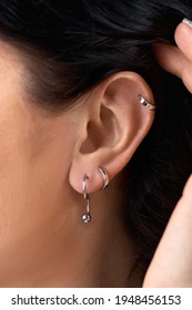 Deer Stud Earring On Woman's Ear Close Up. Piercing