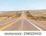 Deer Trail, Colorado on US 36 highway and desert barren landscape blue sky driving car point of view