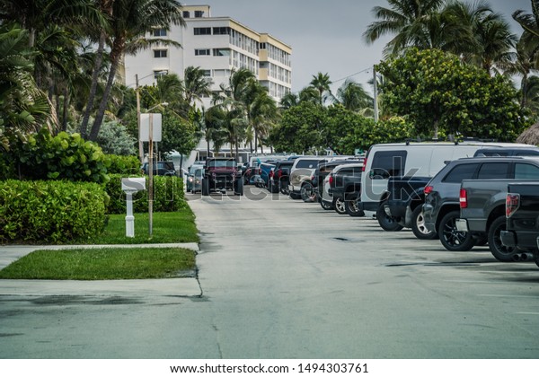 Deerfield Beach, Florida/USA - September 02,\
2019: Hurricane Dorian Surfing Party on Deerfield Beach, FL. Cars\
full spot. Peoples against the\
weather.