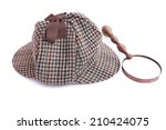 Deerhunter or Sherlock Holmes cap and vintage magnifying glass Isolated on white