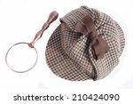 Deerhunter or Sherlock Holmes hat and vintage magnifying glass Isolated on white