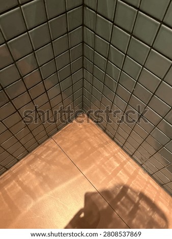 The Deets Of The Nook. Small white ceramic tiles as wall covering material meets terracotta ceramic floors.