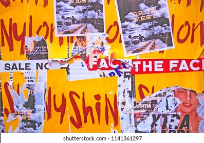 DEFACED POSTERS MAKING COLOURFUL ABSTRACT DESIGN, LONDON, ENGLAND. OCTOBER 2010.  Advertising Posters Fly Posted On City Walls Defaced And Torn From The Wall Make An Interesting Abstract.