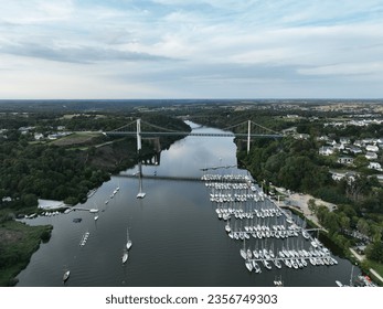 defaultDrone shot of Suspension Bridge of La Roche-Bernard. Located in the Morbihan department of Brittany in north-western France, it is known for its marina along the waterfront of the river named V