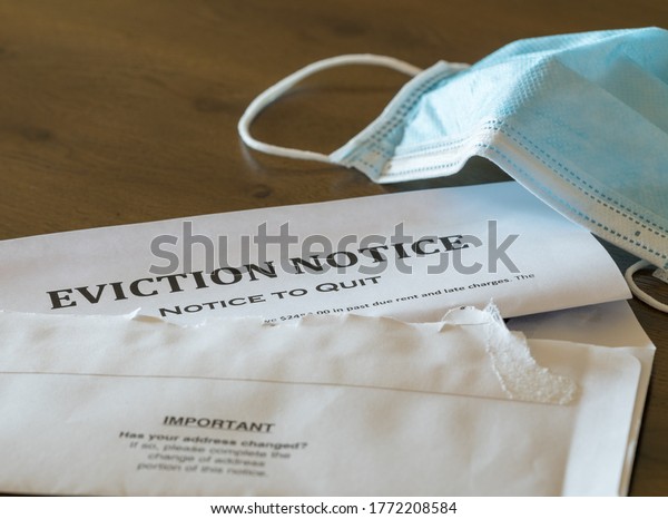 Stock photo of eviction notice for renter with coronavirus face mask