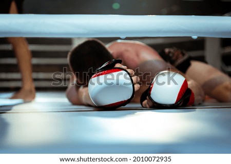 Defeated boxer lies in the ring