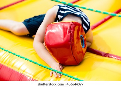 Defeated boy lying in a boxing helmet in the ring - Shutterstock ID 436644397