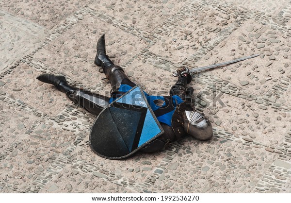 The defeated knight lies in the courtyard of\
the castle. Knight\'s\
tournament.