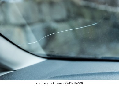 Defective windshield from falling rocks - crack in the safety glass - Shutterstock ID 2241487409