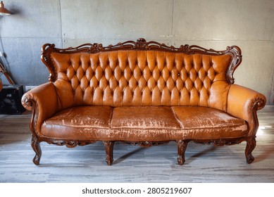 Defects on a leather sofa. Damaged to leather furniture. Close up of damaged leather soft tufted furniture. Bad quality leather