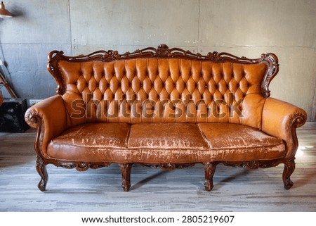 Defects on a leather sofa. Damaged to leather furniture. Close up of damaged leather soft tufted furniture. Bad quality leather