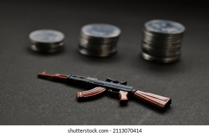 Defence Deals Concept With Coin Stack And Gun Replica Model