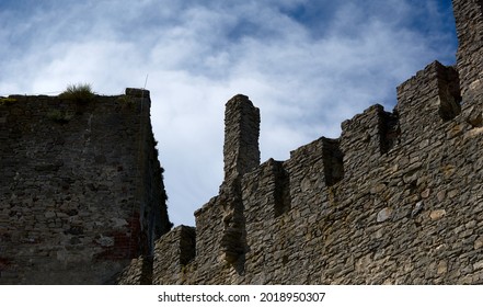 Defensive walls and towers of the castle against the cloudy sky. High quality photo - Shutterstock ID 2018950307