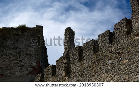 Defensive walls and towers of the castle against the cloudy sky. High quality photo