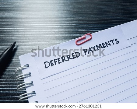 Deferred payments writting on table background. 