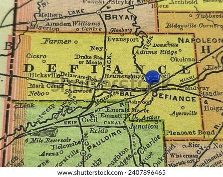 Defiance County, Ohio marked by a blue tack on a colorful vintage map. The county seat is located in the city of Defiance, OH.