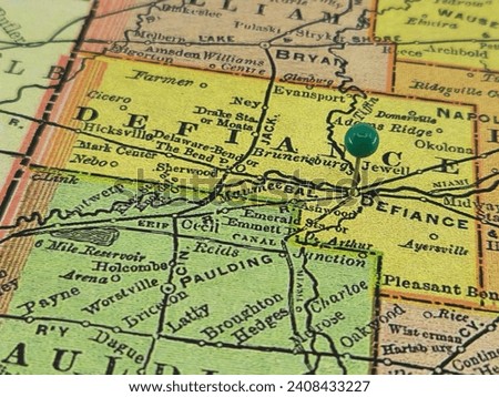 Defiance County, Ohio marked by a green tack on a colorful vintage map. The county seat is located in the city of Defiance, OH.