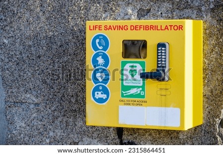 Defibrillator AED on wall in public space for emergency heart resuscitation