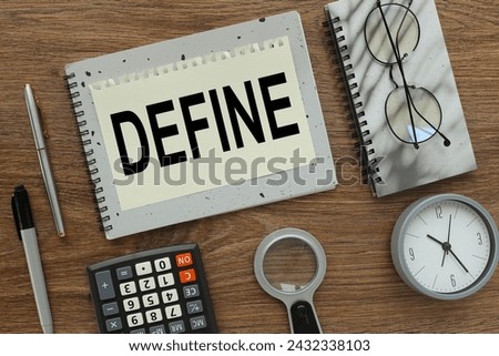DEFINE gray notepad with text on a torn page. a table clock