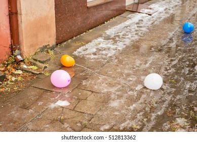 Deflated Colorful Air Balloons On The Street In Autumn After Party