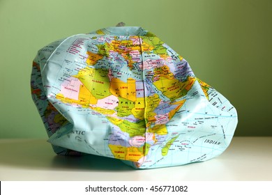 Deflated Globe Illustrating Concept Of Chaotic World And Unsustainable Development