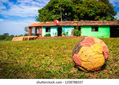 A Deflated Soccer Ball In Front Of A Traditional Rural Paraguayan House In Santa María De Fé, Paraguay