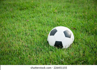 Deflated Soccer Ball On Grass