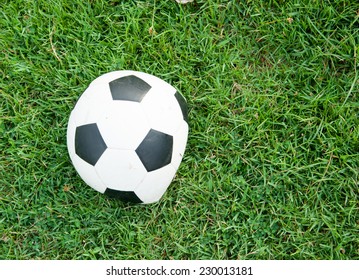 Deflated Soccer Ball On Grass