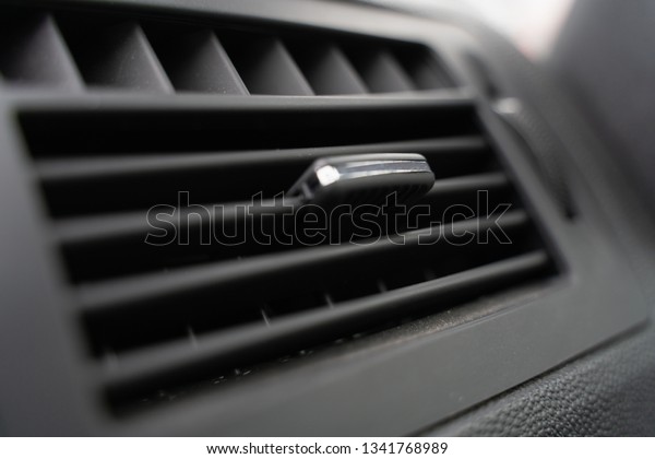 the\
deflector on the grey panel of the car. the heating and air\
conditioning system of the car. interior\
cabin