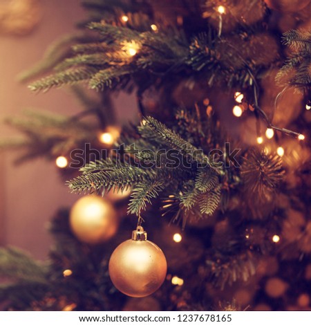 Defocus beautiful dark background. decorations on a Christmas tree and glare of lights
