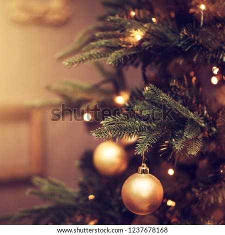 Defocus beautiful dark background. decorations on a Christmas tree and glare of lights