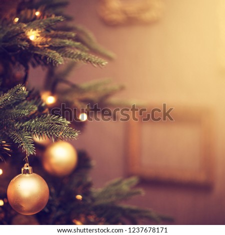 Defocus beautiful dark background. decorations on a Christmas tree and glare of lights