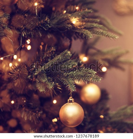 Defocus beautiful dark background. decorations on a Christmas tree and glare of lights
