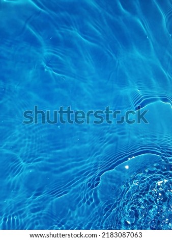 Defocus blurred blue water shining in the sea. rippled water detail background. The water surface in the sea, ocean background. Water wave under sea texture background.