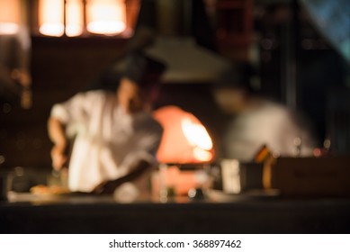 defocus blurred photo of chef working cook some delicious food with exterior kitchen background