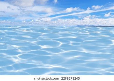 Defocus blurred transparent blue sea and sky. water surface texture with splashes and bubbles. Trendy abstract nature background. Water waves in sunlight with copy space. Blue water shine