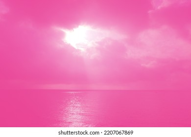 Defocus Blurred Transparent Pink Colored Water Surface Texture With Sun Shining On The Sky. Shining Pink Water Ripple Background. Surface Of Water In The Sea. Pink Shine On The Ocean.