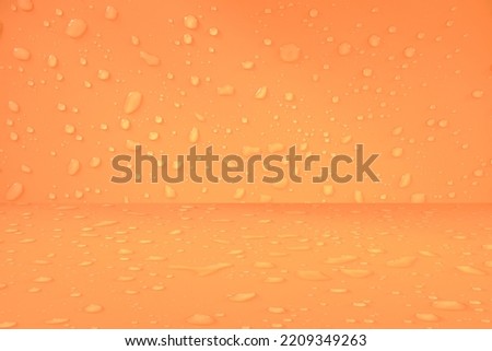 Defocus blurred water drops on orange background. waterdrops detail the background. Water splash, water spray background. Calm orange background with water drop.