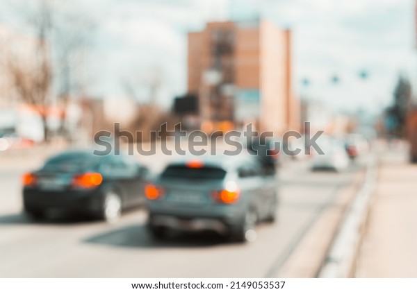 Defocus city road and\
buildings, back view of car on sunny day outdoors. City life\
environment\
abstraction.