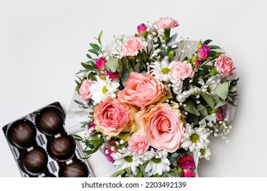 Defocus Flowers And Chocolate. Flowers, Bridal Bouquet Close-up. Decoration Of Roses, Peonies And Ornamental Plants. Gift For Valentines Day Women Day. Mothers Day. White Background. Out Of Focus.