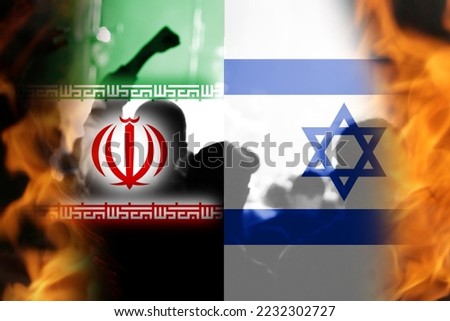 Defocus Israel Iran national flags. Protests man. News, reportage, business background. Israel vs Iran. Battle of two countries. Fire flame. Out of focus.